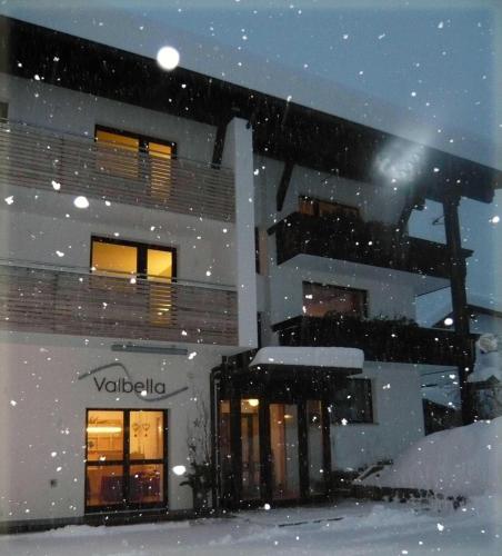 a building covered in snow in front at Valbella Bed & Breakfast in Partenen