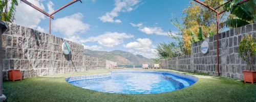 a swimming pool in the middle of a wall at Zoola San Pedro Atitlan in San Pedro La Laguna