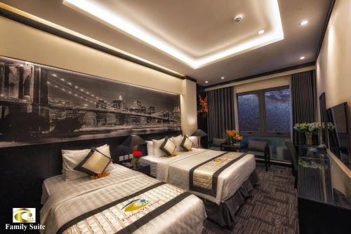 a hotel room with two beds and a painting on the wall at Tuong Vi Hotel Saigon in Ho Chi Minh City