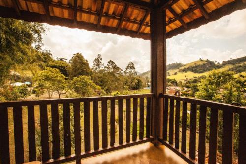 a view from the porch of a house with a view at Pousada Refugio dos Palmares in São Bento do Sapucaí
