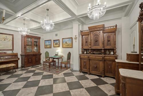 a room with a table and chairs and a chandelier at Houston Towers Inn, Adults-Only, Downtown, Med Ctr, NRG in Houston