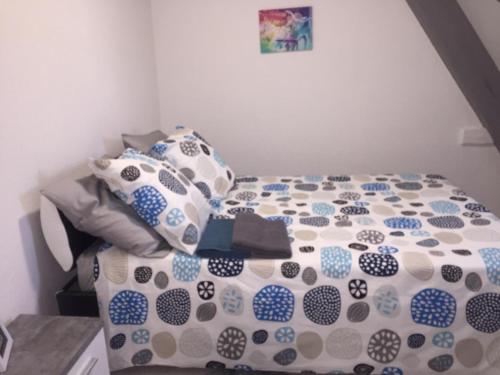 a bed with blue and white sheets and pillows at MyHome Basel 3A44 in Saint-Louis