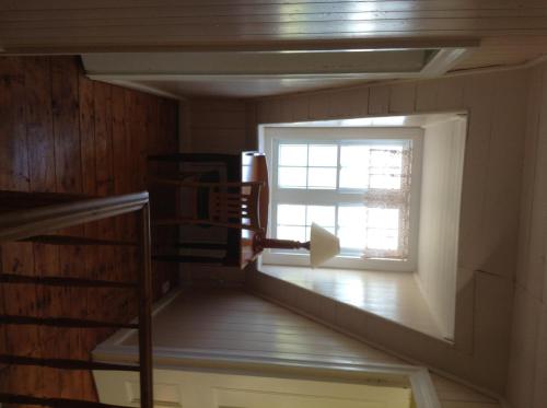 a staircase in a room with a window at Gîte Au Coin De La Berge in Perce