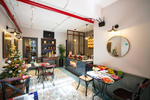 a restaurant with a christmas tree on the counter at Little Saigon Boutique Hotel in Ho Chi Minh City
