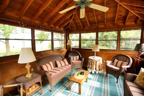 a living room with chairs and a ceiling fan at Deer Creek Winery at Watson Estate in Uniontown