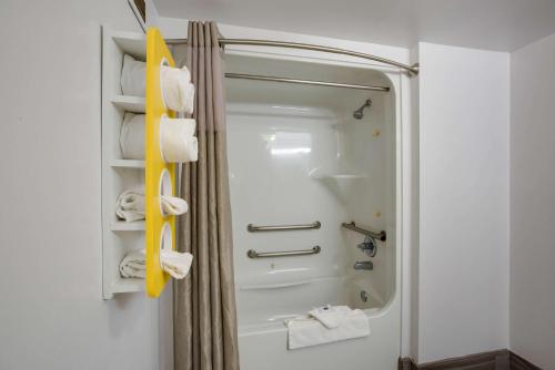 a bathroom with a shower and a white shower backdoor at Motel 6-Suwanee, GA - Gwinnett Center in Suwanee