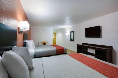 a hotel room with two beds and a flat screen tv at Motel 6-Suwanee, GA - Gwinnett Center in Suwanee