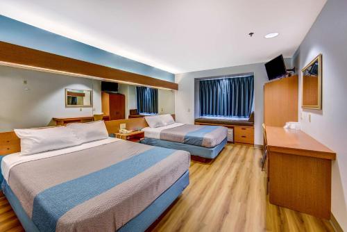a hotel room with two beds and a television at Motel 6-Sutherlin, OR in Sutherlin