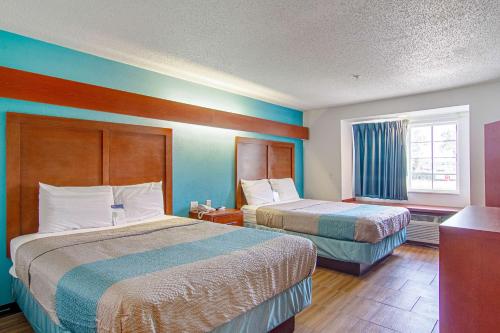 A bed or beds in a room at Americas Best Value Inn & Suites Brunswick