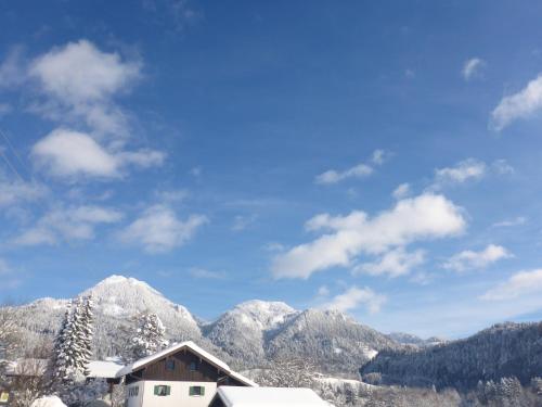 a view of a mountain with snow covered mountains at Pension Oberwirt in Fischbachau