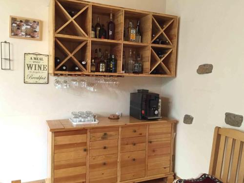 a room with a wooden cabinet with wine bottles at Green Stone Boutique Hotel in Yeghegnadzor