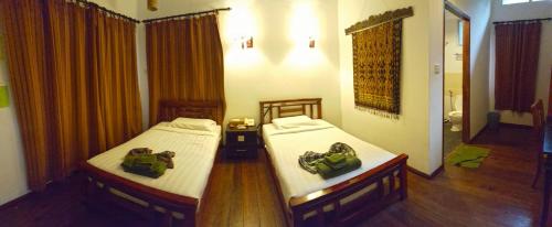 Ένα ή περισσότερα κρεβάτια σε δωμάτιο στο Borneo Nature Lodge