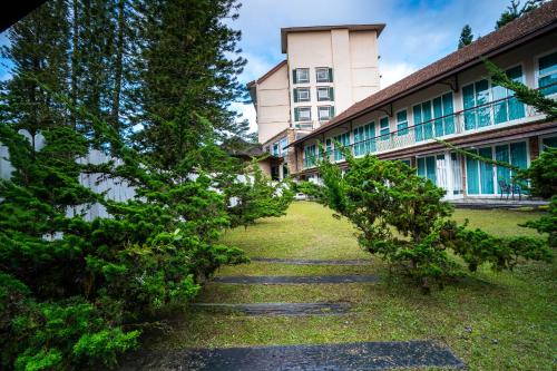 a row of trees in front of a building at Century Pines Resort Cameron Highlands in Cameron Highlands