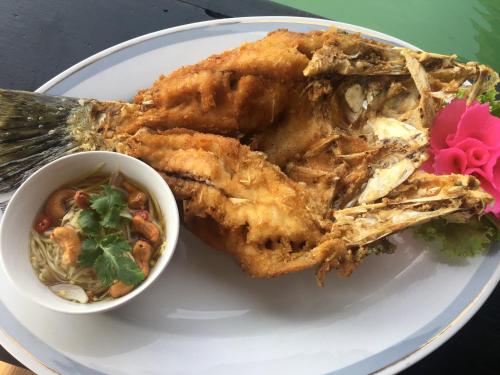 a plate of food with chicken and a bowl of soup at Parama Koh Chang in Ko Chang