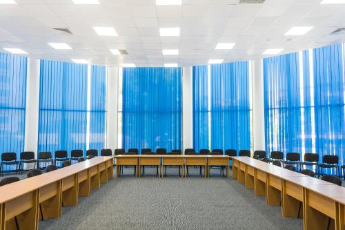 a conference room with chairs and blue curtains at MPM Hotel Arsena - Ultra All Inclusive in Nesebar