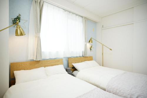 Postel nebo postele na pokoji v ubytování Naha Southerlies Condominium Kumoji