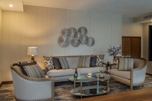 a living room with a couch and chairs and a table at Landmark Amman Hotel & Conference Center in Amman