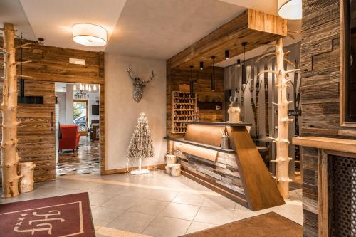 a wine tasting room with wooden walls and a fireplace at Hotel Folgarida in Folgarida