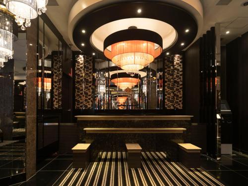 a lobby of a hotel with a chandelier at APA Hotel Kyoto Ekikita Non-smoking in Kyoto