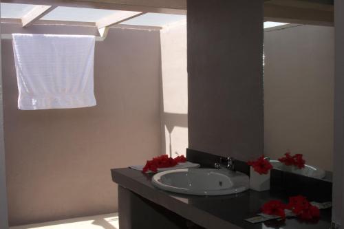 a bathroom with a sink and a mirror at Savaii Lagoon Resort in Fagamalo