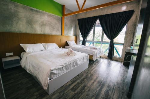 Postel nebo postele na pokoji v ubytování Rick Resort Teluk Intan