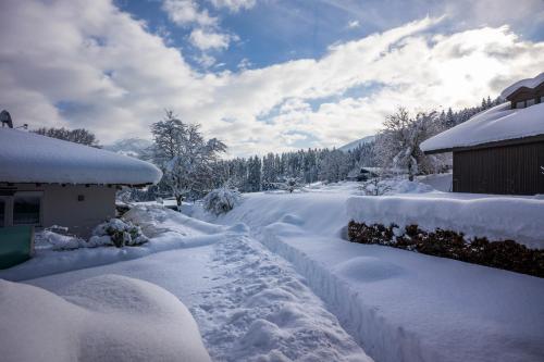 a driveway covered in snow next to a house at Ferienhütte Puutz in Wörgl