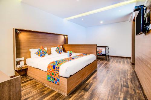 Ένα ή περισσότερα κρεβάτια σε δωμάτιο στο FabHotel Tranquil Heights Kodaikanal