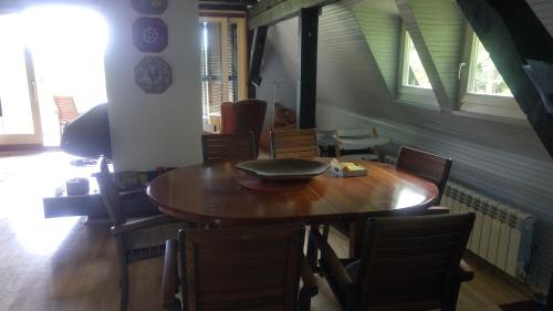 a dining room with a wooden table and chairs at Architect's Home Plitvice in Plitvička Jezera