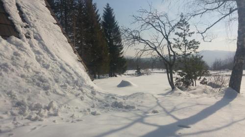 a pile of snow on the side of a house at Architect's Home Plitvice in Plitvička Jezera