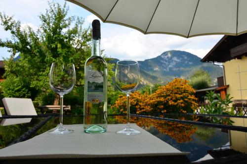 a bottle of wine and two wine glasses on a table at Haus Cäcilia in Sankt Martin bei Lofer