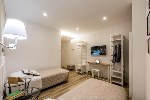 a small room with two beds and a desk at Il Parco dei Poeti B&B in Cellino Attanasio