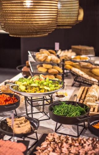 a buffet with many different types of food on display at Comfort Hotel Kista in Stockholm
