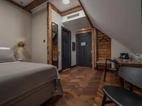 a bedroom with a bed and a wooden floor at Boutique Hotel Rosenplänter in Pärnu