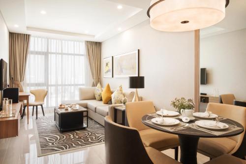 a living room with a couch and a table at Oakwood Residence Saigon in Ho Chi Minh City