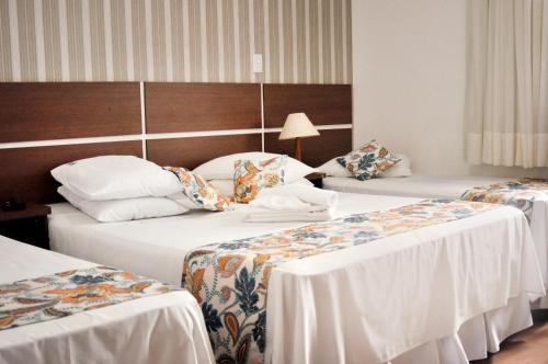 Cama ou camas em um quarto em Hotel Vitoria Marchi