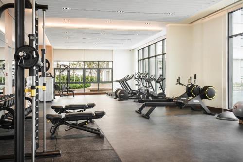 a gym with several treadmills and cardio machines at Oakwood Residence Saigon in Ho Chi Minh City