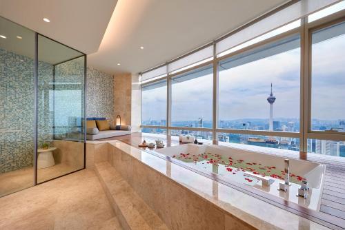 a bathroom with a tub and a large window at Banyan Tree Kuala Lumpur in Kuala Lumpur