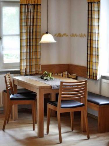 a dining room table with two chairs and a table and chairsktop at FrongaHOF in Waldkirchen