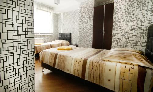 a bedroom with two beds and a window at Apartments Belgrade in Belgrade
