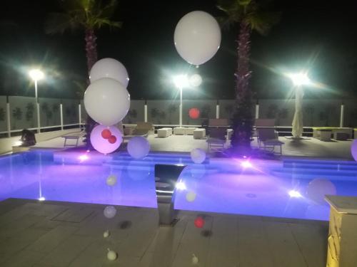 a swimming pool at night with balloons around it at Il Parco dei Poeti B&B in Cellino Attanasio