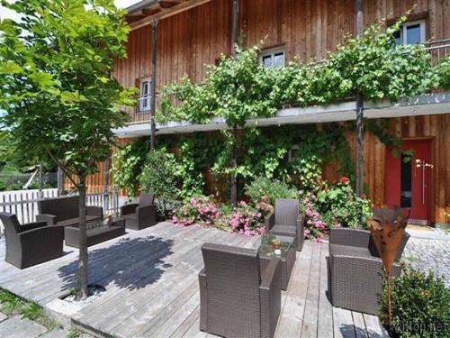 a group of chairs sitting on a wooden patio at FrongaHOF in Waldkirchen