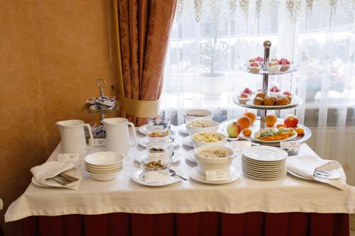 a table with plates and bowls of food on it at Edem Hotel Lviv in Lviv