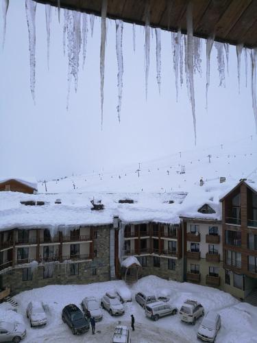 a group of cars parked in a parking lot with icicles at Frozen View New Gudauri in Gudauri