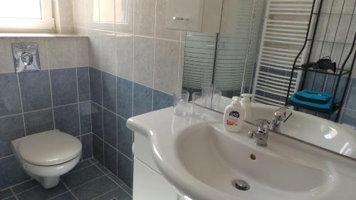 a bathroom with a white sink and a toilet at Villa Finiki Messinia upstairs in Foiníki
