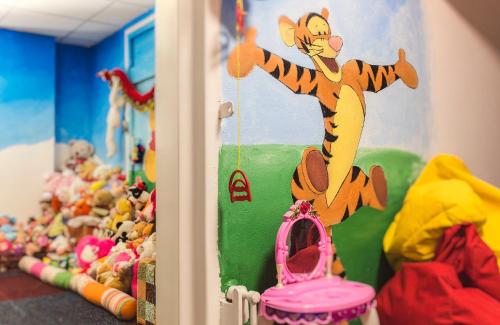 a cake shaped like a tiger on top of a room with toys at Prima Music Hotel in Eilat