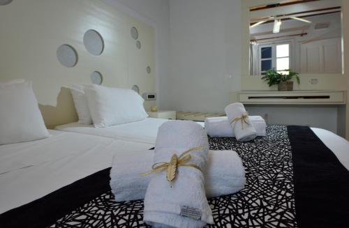 A bed or beds in a room at Adonis Rooms