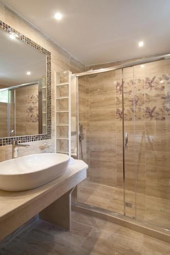 a bathroom with a large sink and a shower at Skiathos Island Villas in Skiathos