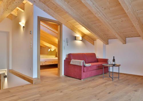 a living room with a red couch and a table at Arvenhof in Serfaus