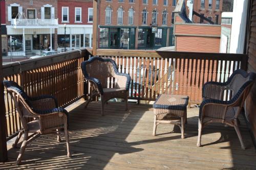 a group of chairs and a table on a balcony at Backwoods Bed and Bath in McGregor