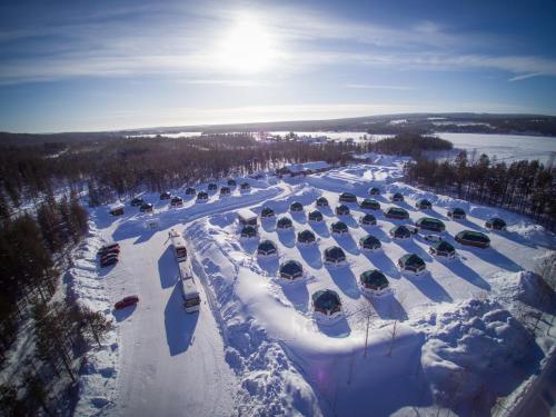 an aerial view of a parking lot covered in snow at Arctic SnowHotel & Glass Igloos in Sinettä